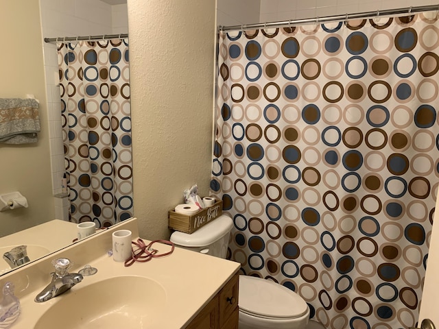 bathroom featuring a shower with curtain, vanity, and toilet