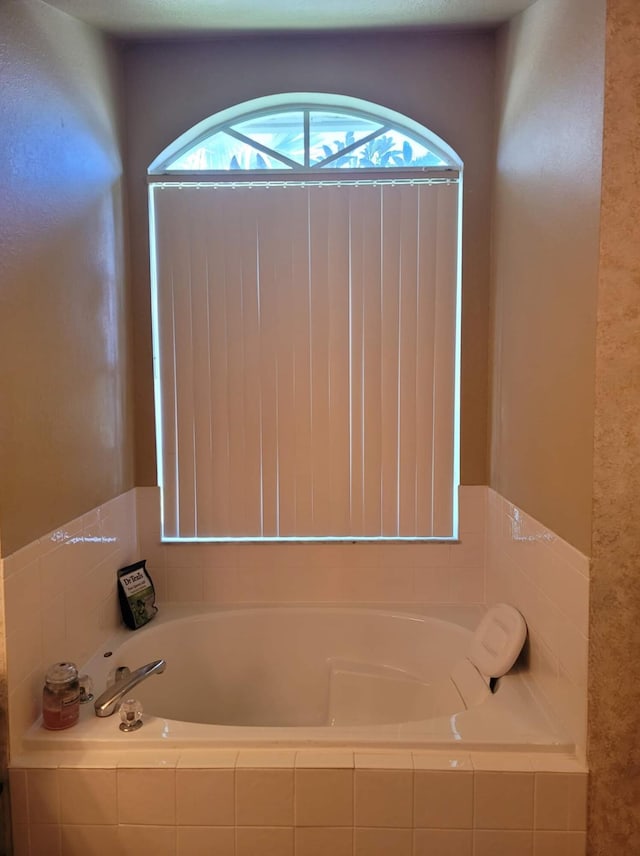 bathroom featuring a relaxing tiled tub