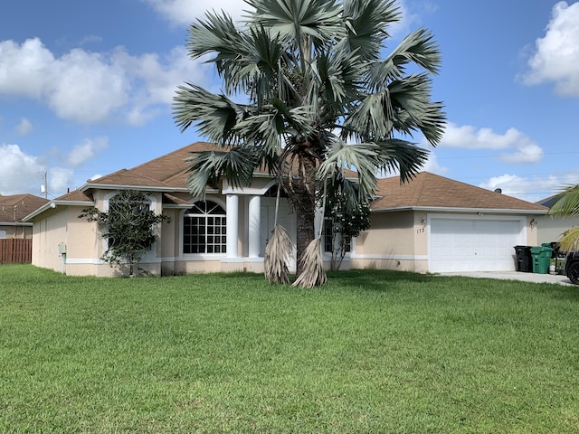 view of front facade with a garage and a front yard