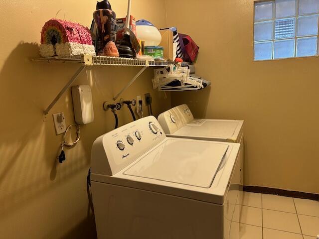 laundry room with separate washer and dryer and light tile patterned floors