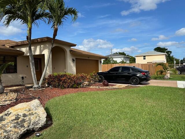 view of property exterior with a garage and a yard