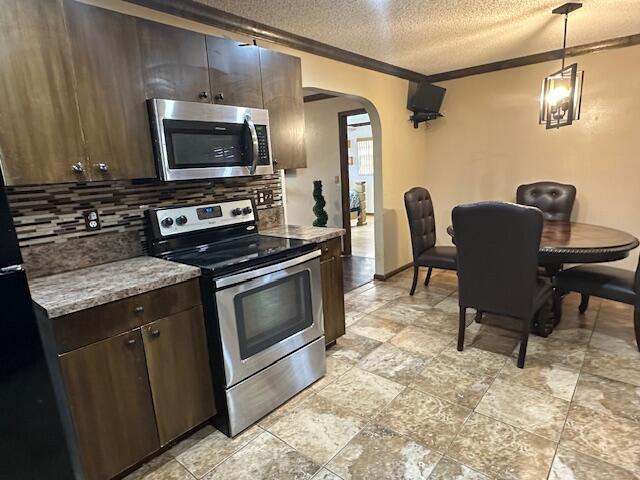 kitchen with dark brown cabinets, pendant lighting, a textured ceiling, and appliances with stainless steel finishes