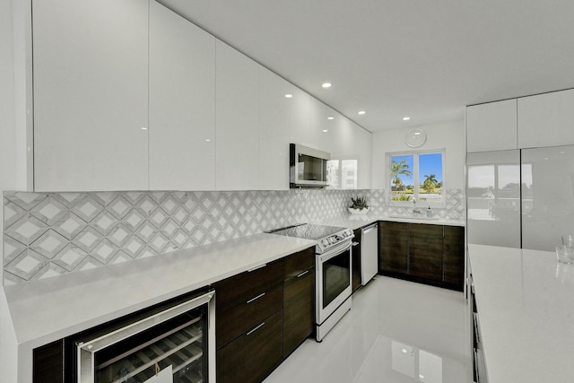 kitchen with wine cooler, white cabinetry, dark brown cabinets, and appliances with stainless steel finishes