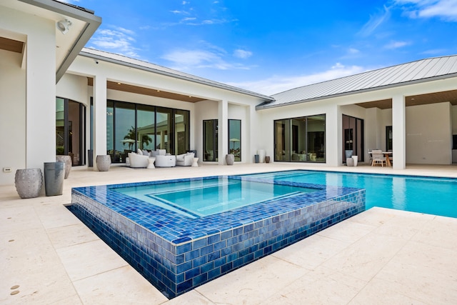 view of swimming pool featuring an in ground hot tub and a patio