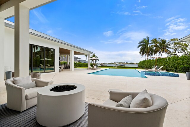 view of patio / terrace featuring an outdoor living space with a fire pit