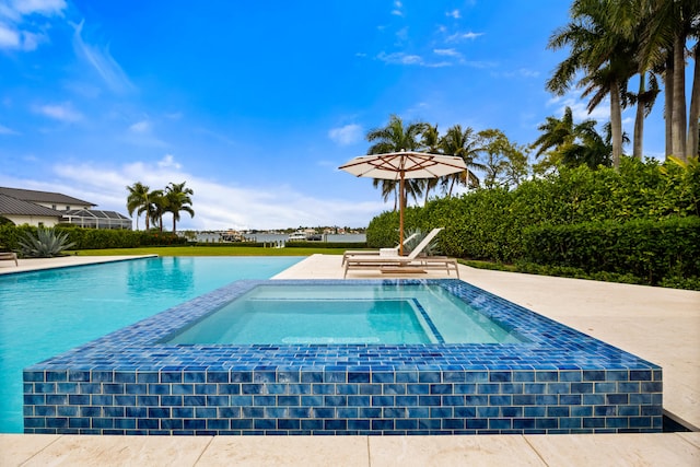 view of pool featuring an in ground hot tub and a patio area