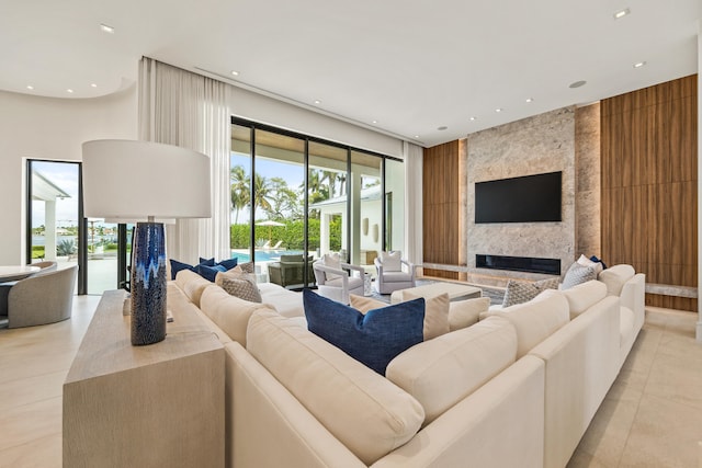 tiled living room with a large fireplace and a healthy amount of sunlight