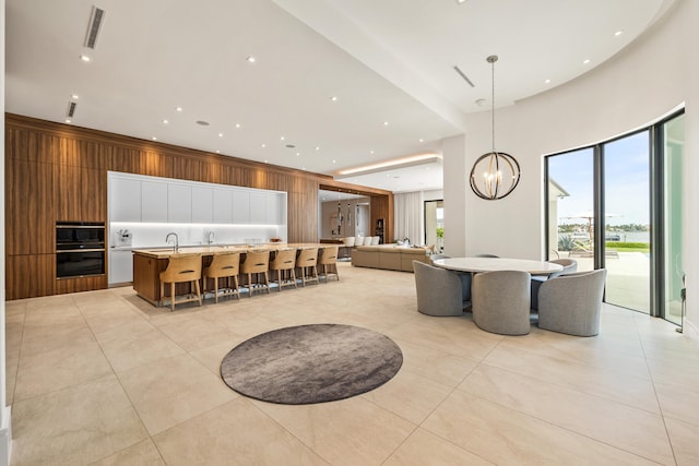 interior space featuring sink, light tile patterned floors, and a chandelier