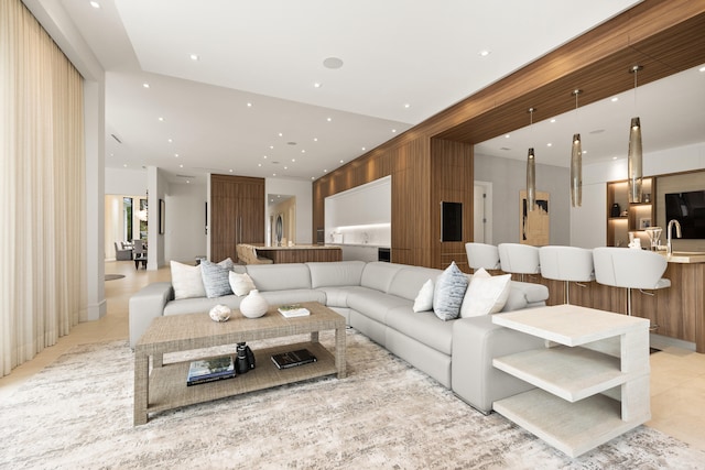 living room featuring light tile patterned flooring and sink