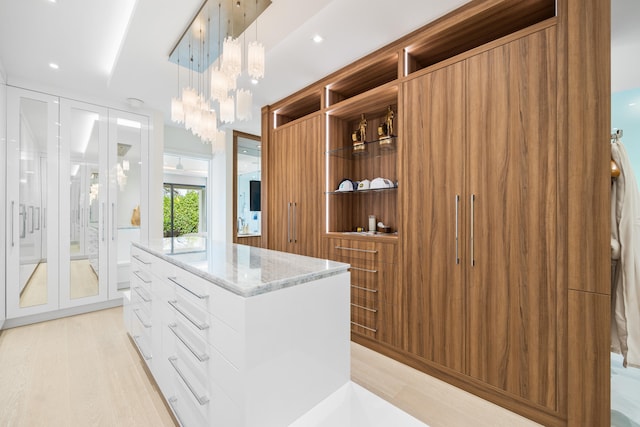 spacious closet featuring light hardwood / wood-style floors