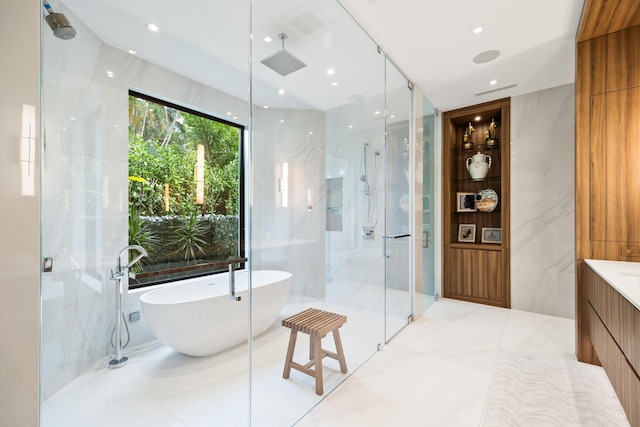 bathroom with vanity, independent shower and bath, and tile walls