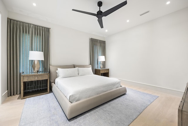 bedroom with light hardwood / wood-style floors and ceiling fan