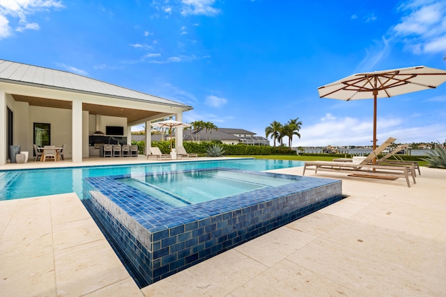 view of pool featuring a patio, an outdoor bar, and an in ground hot tub