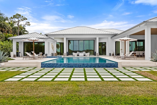 back of house with a lawn and a patio area