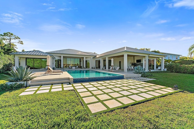 rear view of house featuring a yard and a patio