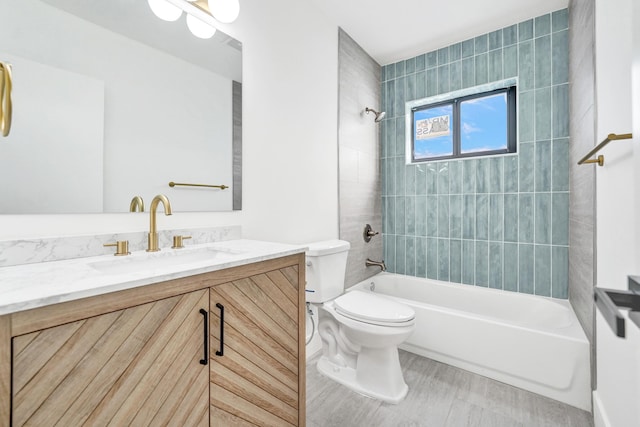 full bathroom featuring vanity, toilet, and tiled shower / bath