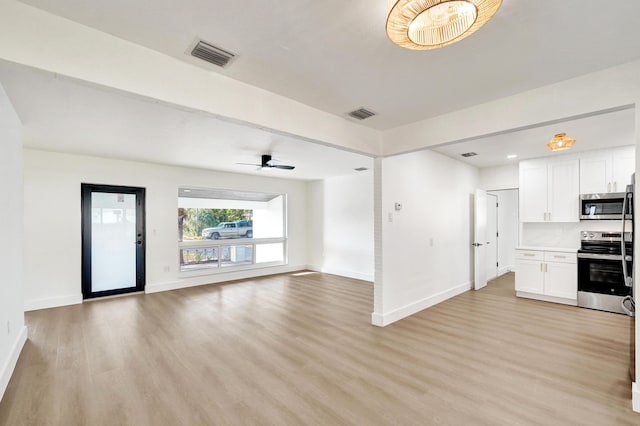 unfurnished living room with ceiling fan and light wood-type flooring