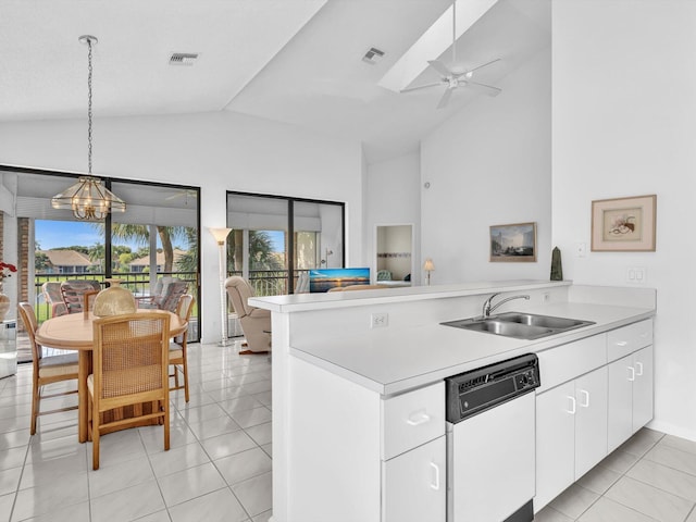 kitchen featuring lofted ceiling, white dishwasher, white cabinets, sink, and kitchen peninsula