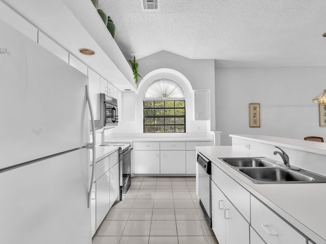 kitchen featuring white refrigerator, white cabinetry, black range with electric stovetop, and sink