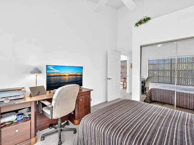 carpeted bedroom featuring ceiling fan and a closet