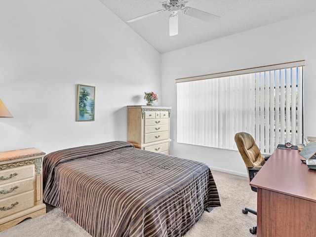 carpeted bedroom featuring a textured ceiling, vaulted ceiling, and ceiling fan