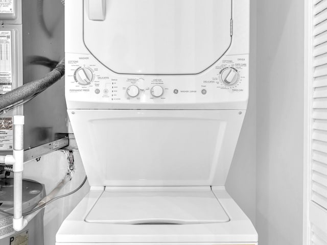 washroom featuring stacked washer and clothes dryer