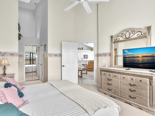 bedroom featuring a towering ceiling and ceiling fan