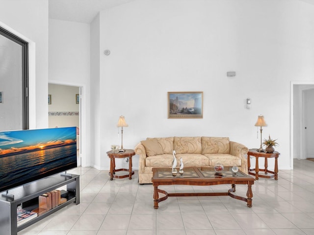 tiled living room featuring a high ceiling