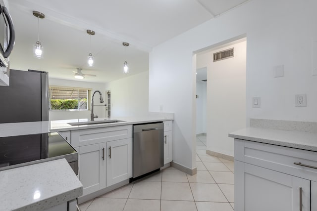 kitchen featuring white cabinetry, sink, ceiling fan, hanging light fixtures, and stainless steel appliances