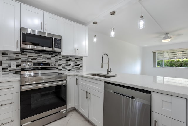 kitchen featuring light tile patterned floors, stainless steel appliances, white cabinetry, and sink