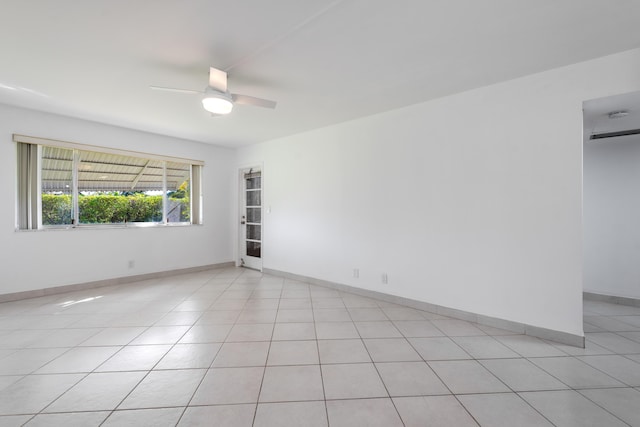 empty room featuring ceiling fan and light tile patterned flooring