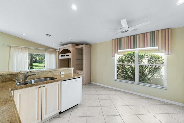 kitchen with light stone countertops, sink, ceiling fan, white dishwasher, and vaulted ceiling