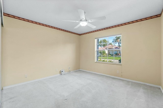 spare room featuring ceiling fan and light colored carpet