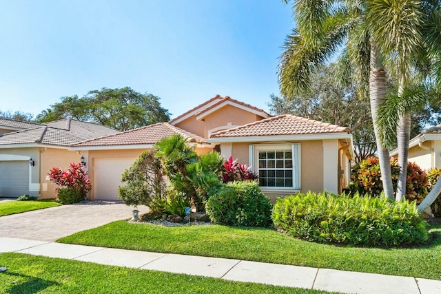 mediterranean / spanish-style home with a front yard and a garage