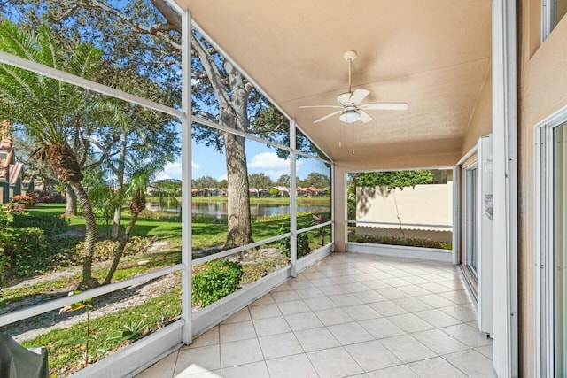 unfurnished sunroom with a water view, ceiling fan, and lofted ceiling