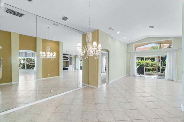 spare room featuring plenty of natural light, light tile patterned floors, a chandelier, and high vaulted ceiling