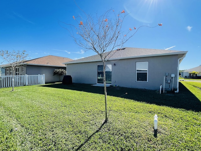 back of property with a lawn