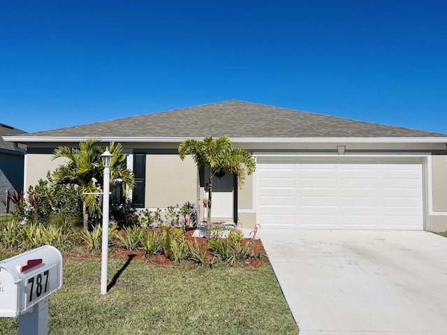 single story home featuring a garage and a front lawn