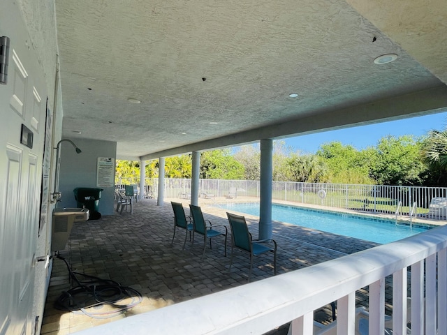 view of swimming pool with a patio