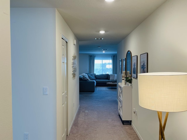 hallway with light colored carpet