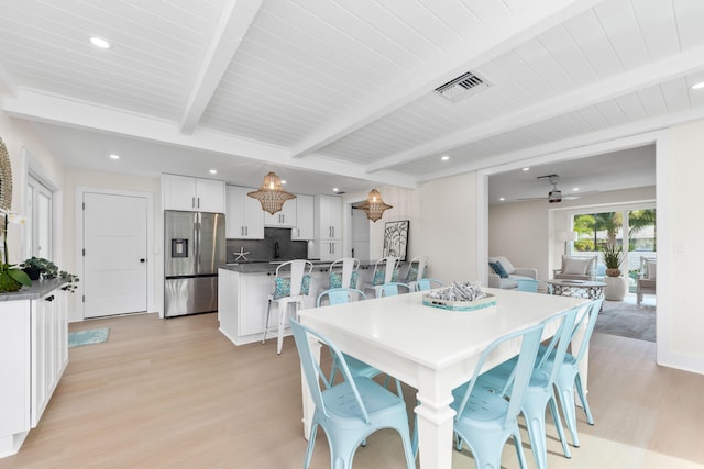 dining space featuring ceiling fan, beam ceiling, and light hardwood / wood-style flooring