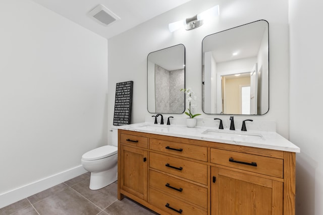 bathroom featuring tile patterned flooring, vanity, and toilet