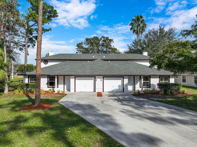 single story home featuring a front yard and a garage