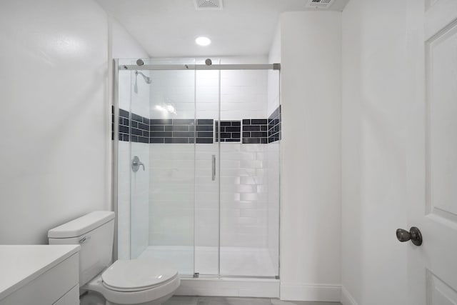 bathroom with vanity, toilet, and a shower with shower door