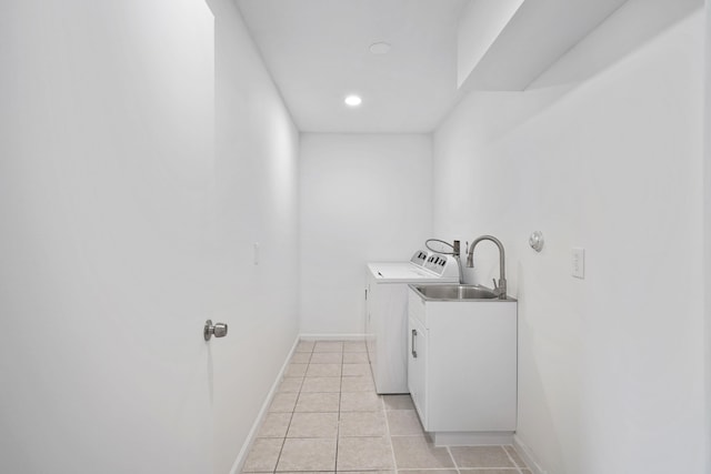 clothes washing area featuring separate washer and dryer, sink, and light tile patterned floors