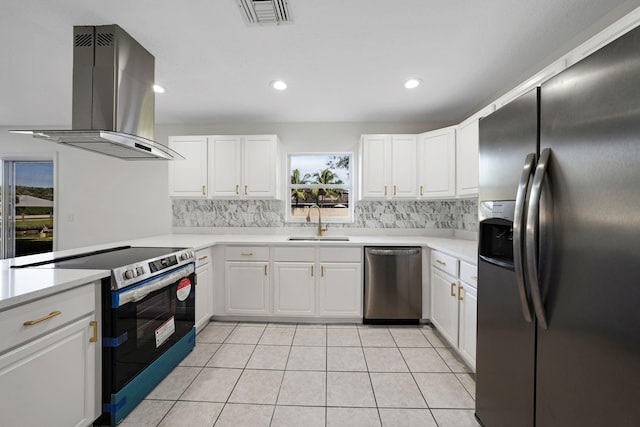 kitchen featuring appliances with stainless steel finishes, white cabinetry, sink, backsplash, and wall chimney range hood