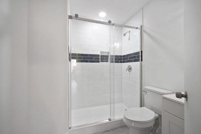 bathroom featuring an enclosed shower, a textured ceiling, and toilet