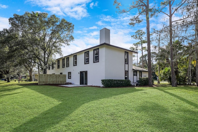 view of side of home with a yard