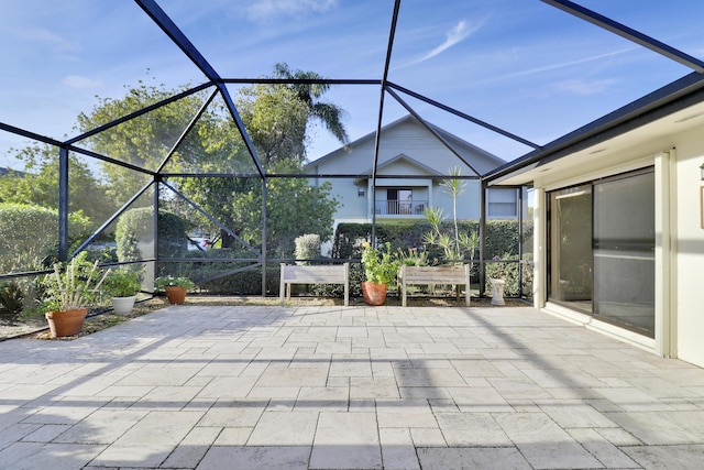 view of patio featuring glass enclosure