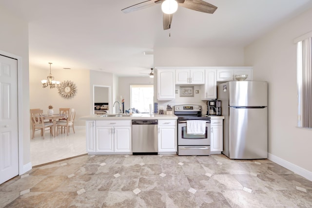 kitchen with light tile patterned floors, sink, white cabinetry, hanging light fixtures, and stainless steel appliances